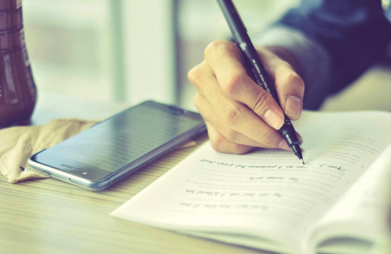 Person analyzing financial data and market trends on multiple screens